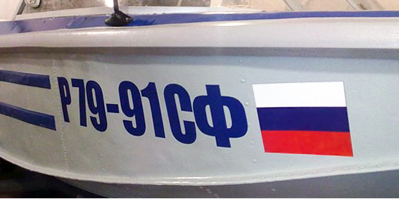 номер старого образца с флагом на борту алюминиевой лодки